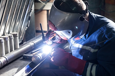 Closeup of Man Wearing Mask Welding in a Workshop